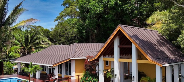 Relax at this hillside retreat that overlooks the lush forest and the Caribbean. in West End